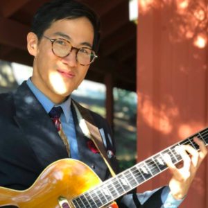 Vic Wong outdoors with archtop